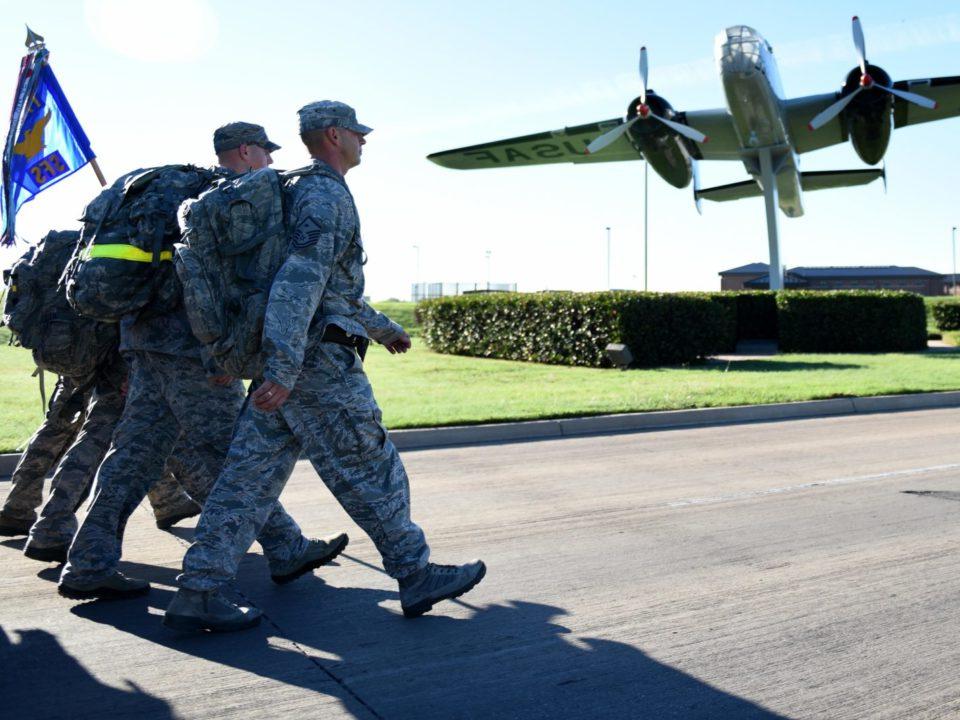 military members walking towards plane